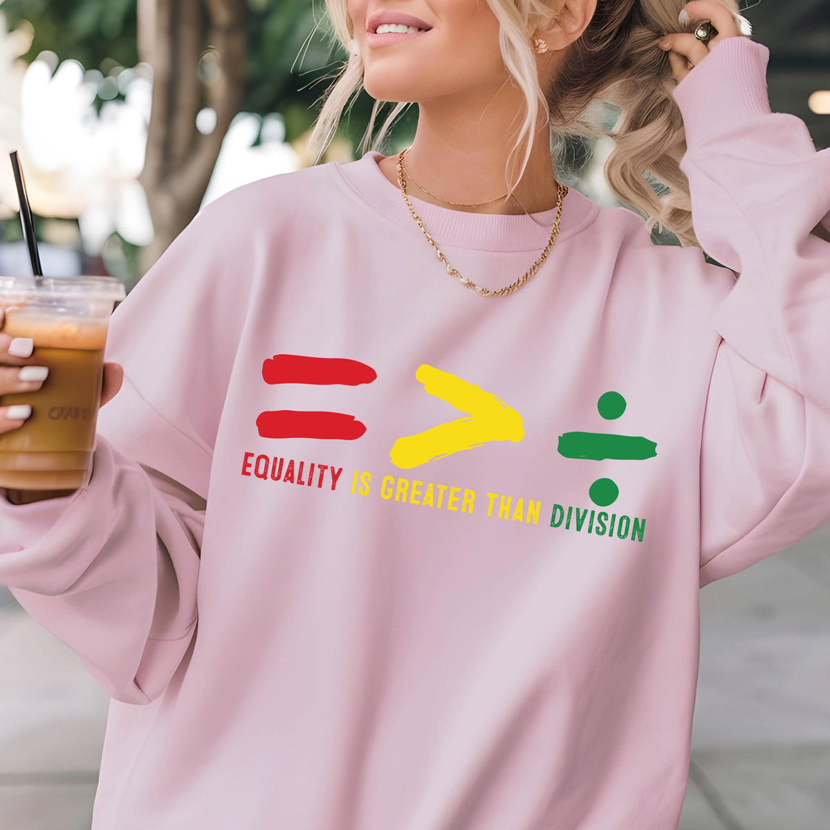 May include: Pink sweatshirt with a graphic design of an equal sign, a greater than sign, and a division sign. The text "Equality is greater than division" is printed below the graphic.