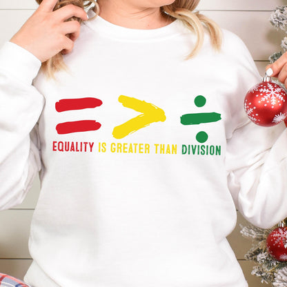 May include: White sweatshirt with a red equals sign, a yellow greater than sign, and a green division sign. The text "Equality is greater than division" is printed below the symbols.