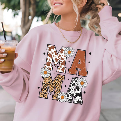 May include: Pink sweatshirt with the word "MAMA" printed in large letters. Each letter is decorated with a different animal print: cow, leopard, and cow. The letters are surrounded by white daisies.