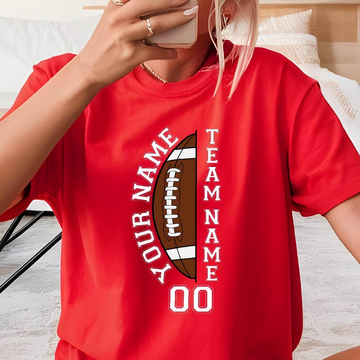 May include: Red t-shirt featuring a football design with the text "YOUR NAME" in a semi-circle and "TEAM NAME" vertically. The football graphic is brown and white, with the number "00" below.