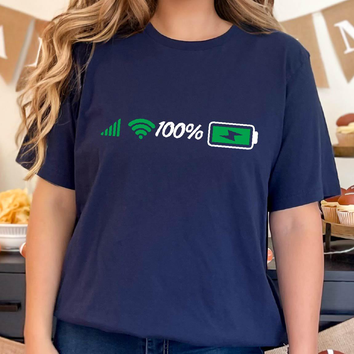 May include: A navy blue t-shirt with a white graphic of a signal bar, wifi symbol, the number 100%, and a green battery icon with a lightning bolt inside. The battery is fully charged.