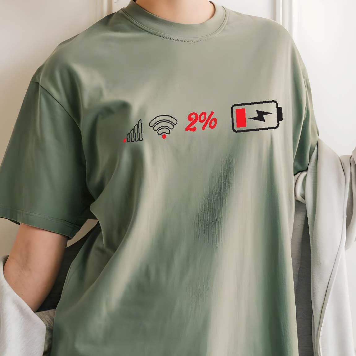 May include: A green t-shirt with a graphic of a low signal bar, a wifi symbol, the number 2%, and a battery icon with a lightning bolt inside. The battery icon is almost completely empty.