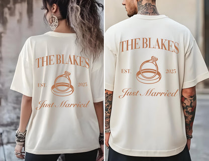 May include: Two white t-shirts with the text "The Blakes" and "Est. 2025 Just Married" printed on the back. The design features a stylized ring with a diamond.