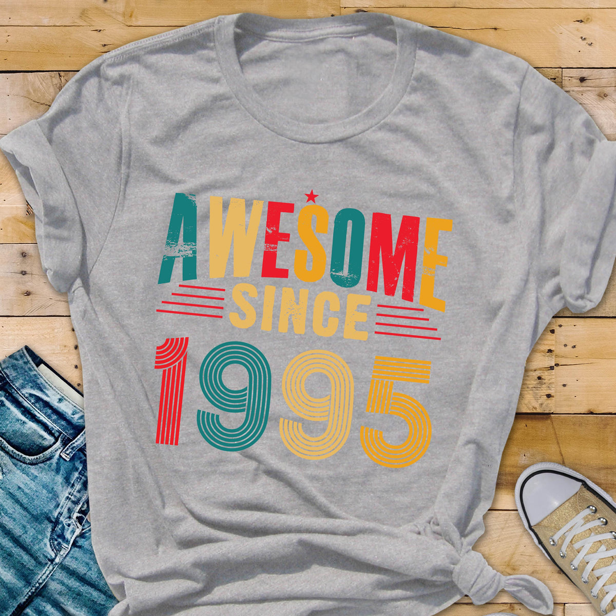 May include: Gray t-shirt with the text "Awesome Since 1995" in colorful retro-style lettering.