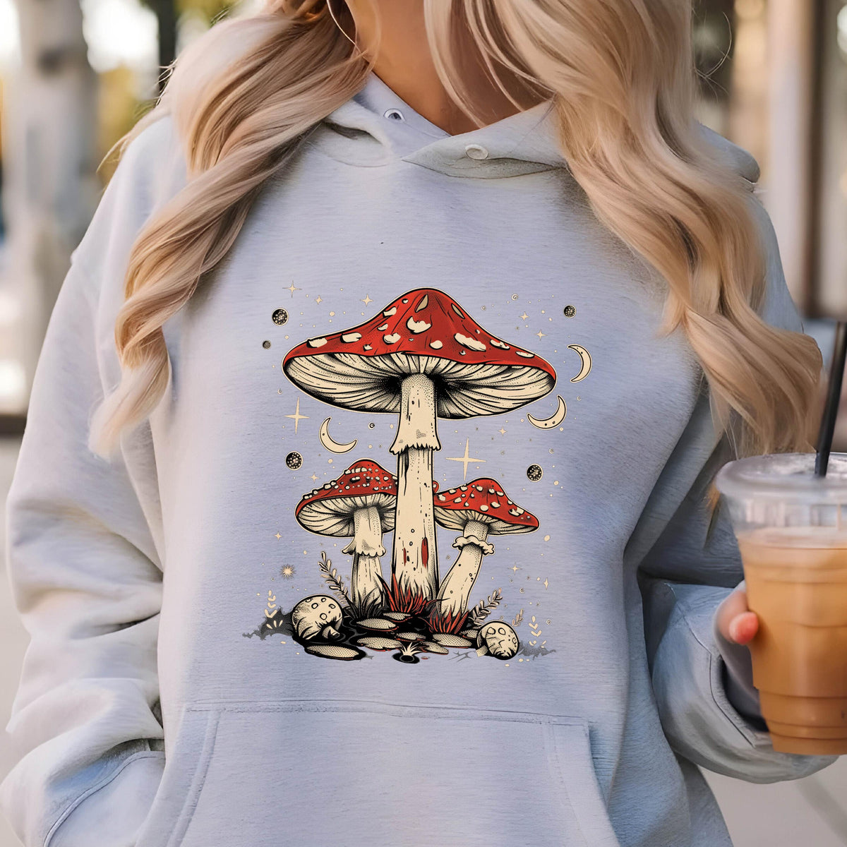 May include: A light gray hoodie with a graphic of three red and white mushrooms with white stems against a blue background with white stars and crescent moons.