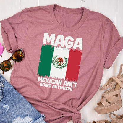 May include: A pink t-shirt with the text "MAGA Mexican Ain't Going Anywhere" and a distressed image of the Mexican flag.