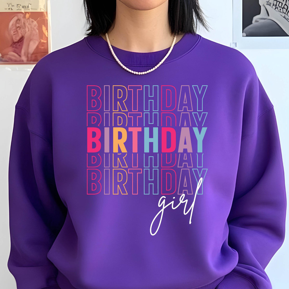 May include: Purple sweatshirt with the text "Birthday girl" in rainbow colors.