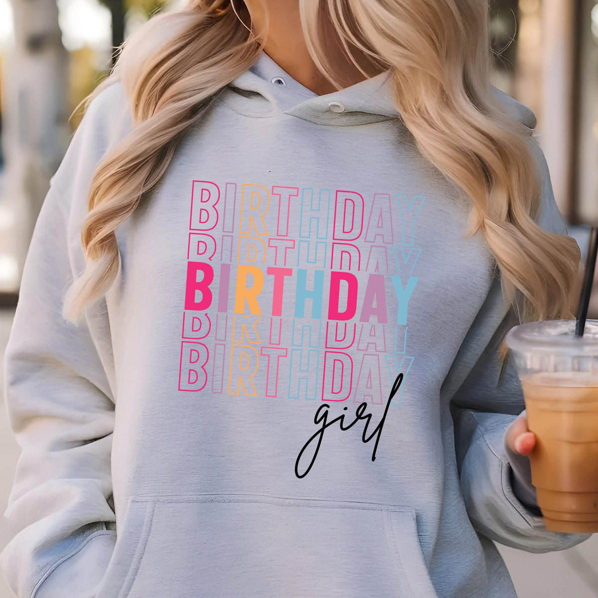 May include: A gray hoodie with the text "BIRTHDAY girl" printed on it in a stacked, colorful design. The text is repeated multiple times in different colors, including pink, blue, yellow, and orange.