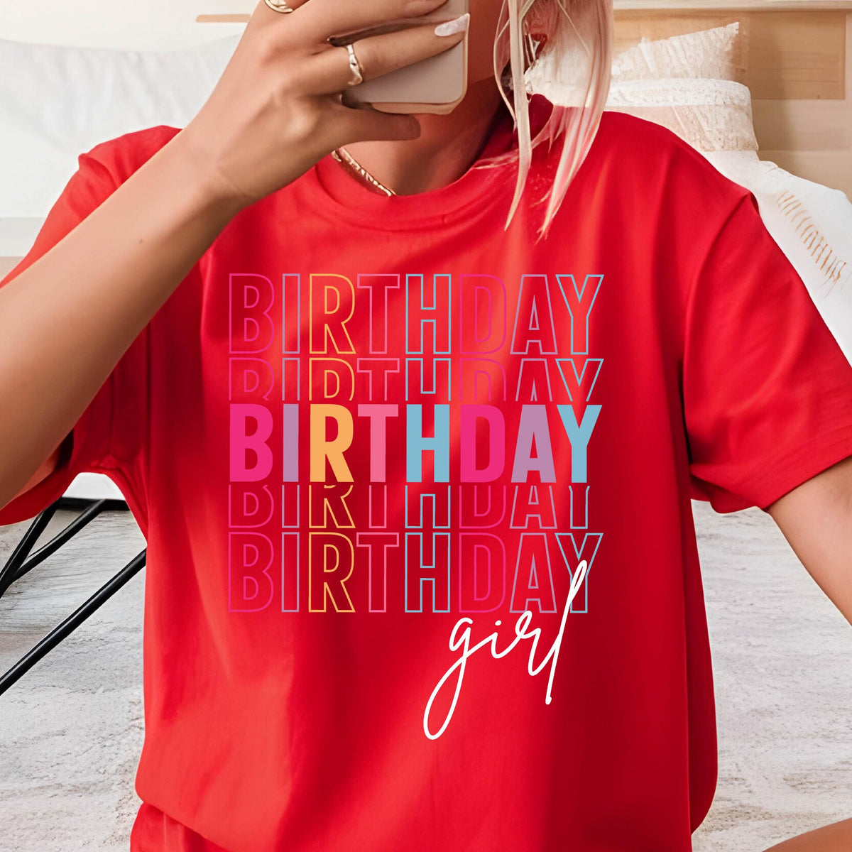 May include: Red t-shirt with the text "Birthday girl" in rainbow colors. The word "Birthday" is repeated multiple times in a stacked design.