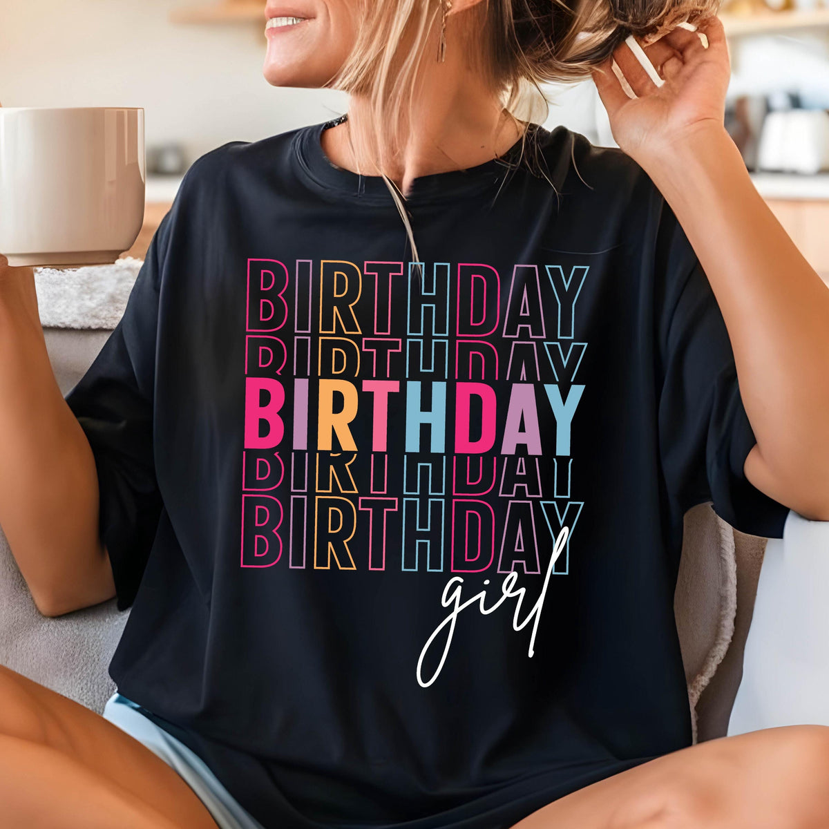May include: Black t-shirt with the text "Birthday girl" in rainbow colors. The text is stacked and repeated multiple times.