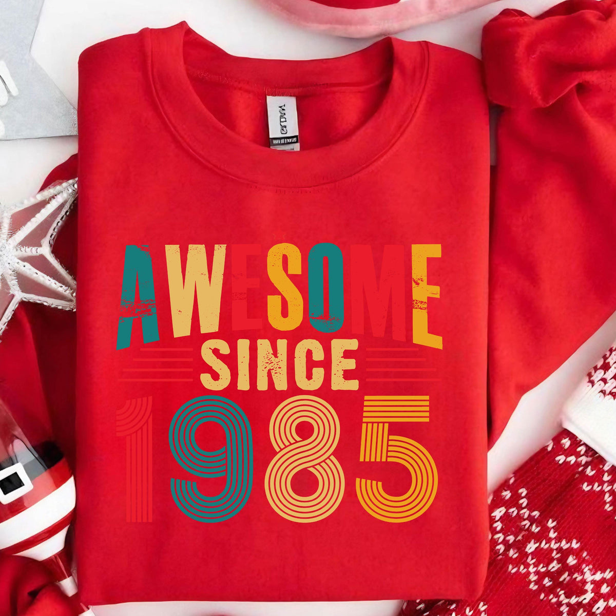 May include: Red sweatshirt with a vintage-style graphic that says "Awesome Since 1985" in rainbow colors.