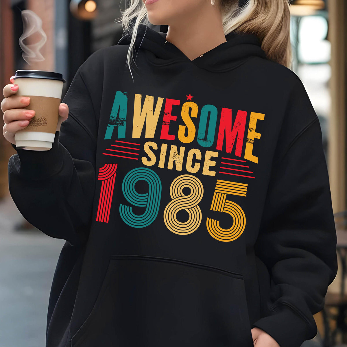 May include: Black hooded sweatshirt with a vintage-style graphic that says "Awesome Since 1985" in rainbow colors.