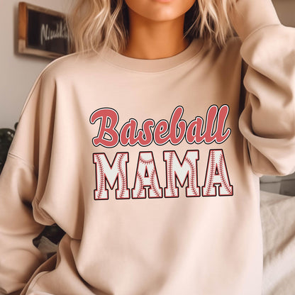 May include: A beige crewneck sweatshirt featuring the text Baseball MAMA printed on the front. The word Baseball is in a red script font, while the word MAMA is in a white block font with red outlines and a baseball stitch pattern inside.
