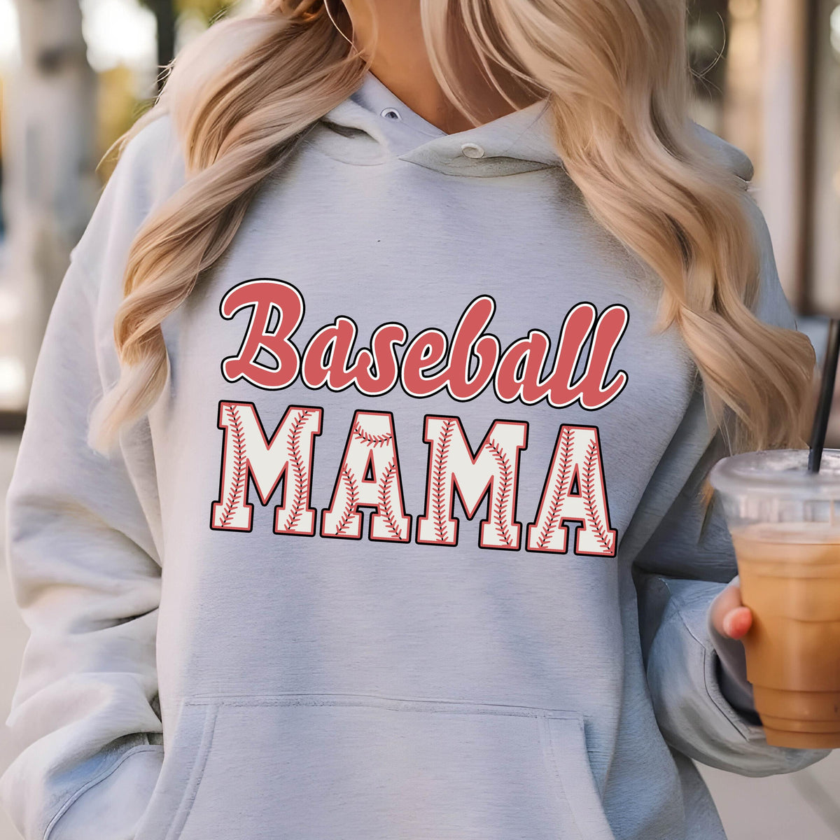 May include: A light blue hooded sweatshirt featuring the text Baseball MAMA printed on the front. The word Baseball is in a red script font, while the word MAMA is in large block letters with a white baseball stitch pattern and red outlines.