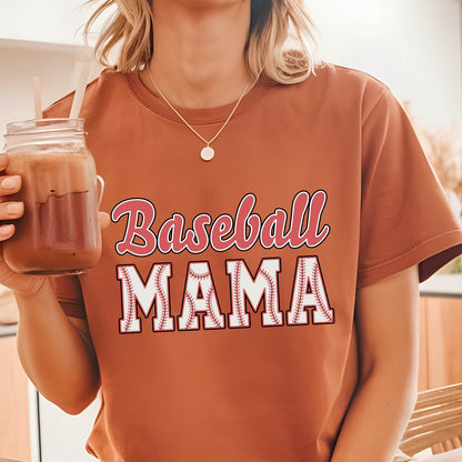 May include: A brown t-shirt with the text "Baseball Mama" in red and white lettering. The letters are outlined in black and have a baseball stitch design.