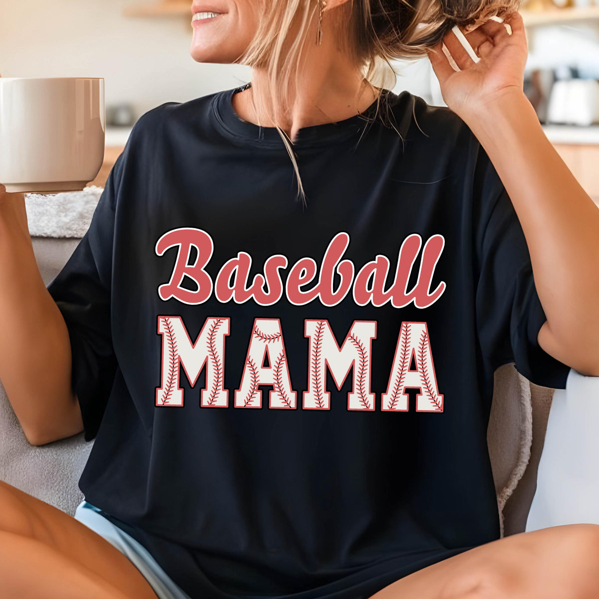 May include: A black t-shirt with the text "Baseball Mama" in red and white. The word "Mama" is surrounded by a white baseball stitch design.