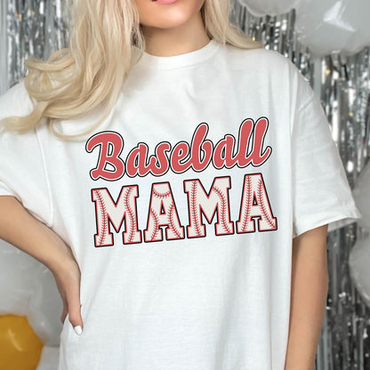 May include: White t-shirt with red text that says "Baseball Mama" with a baseball graphic design.