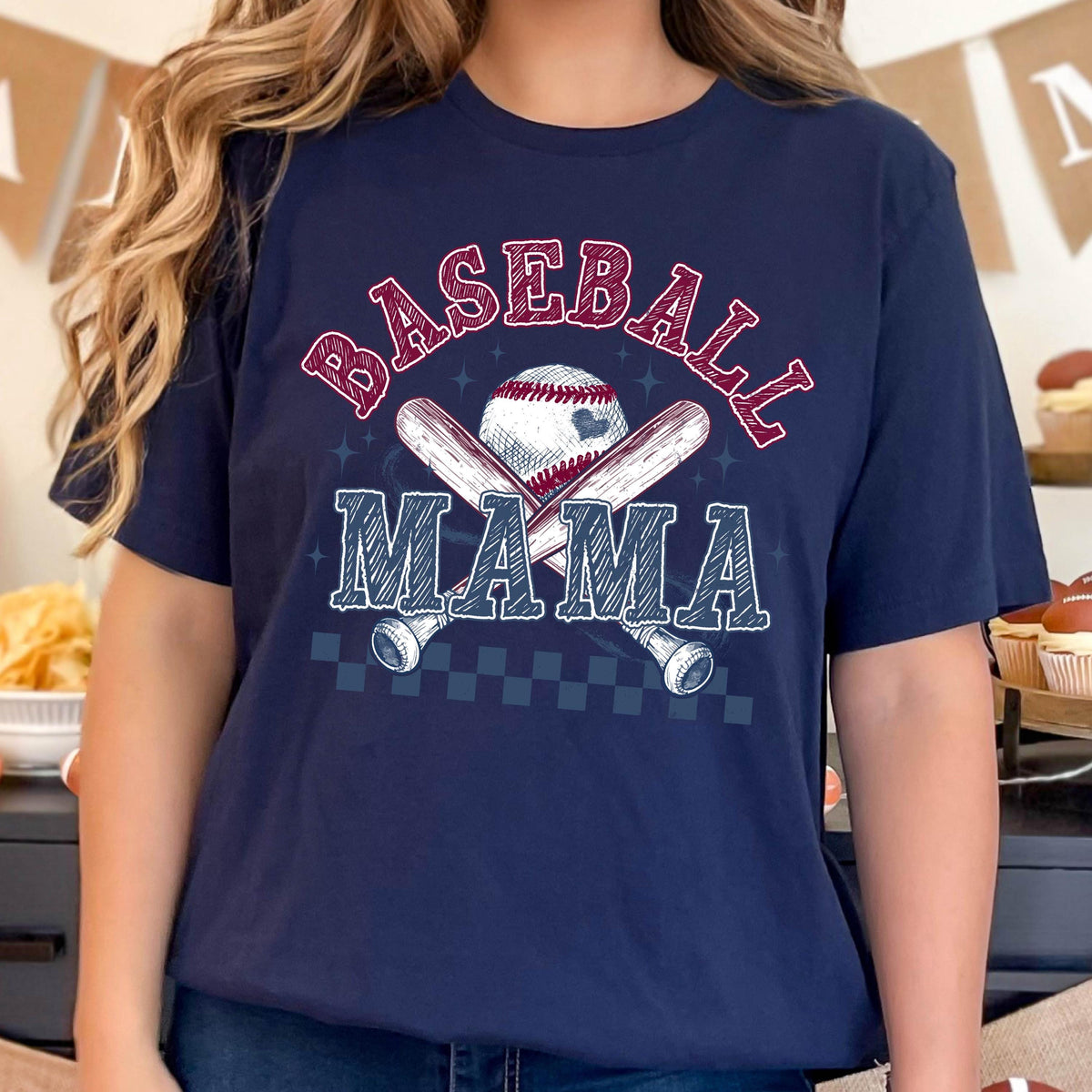 May include: Navy blue t-shirt with a baseball, bats, and the text "BASEBALL MAMA" in white and red lettering.