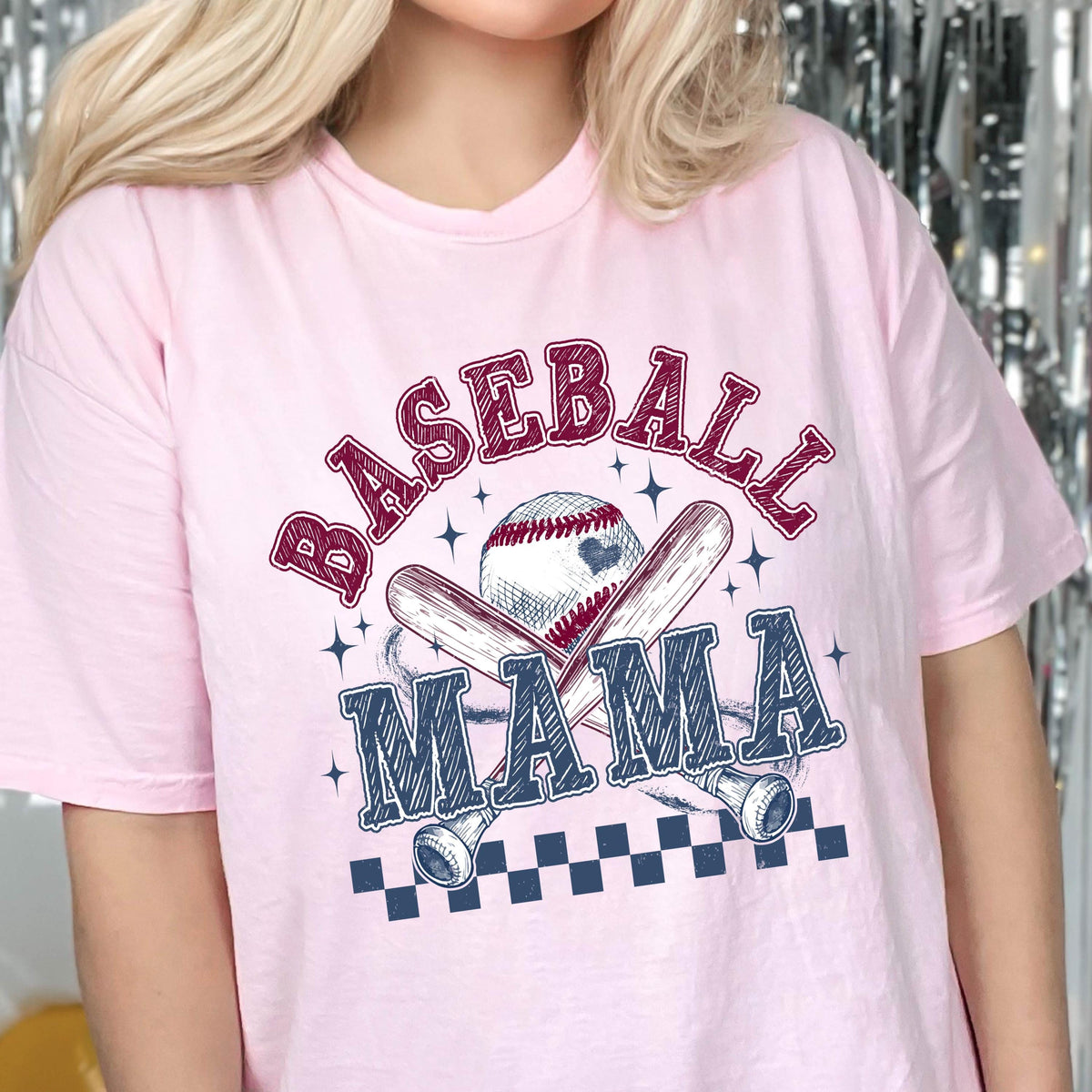 May include: Pink t-shirt with a baseball graphic and the text "Baseball Mama" in a vintage style.