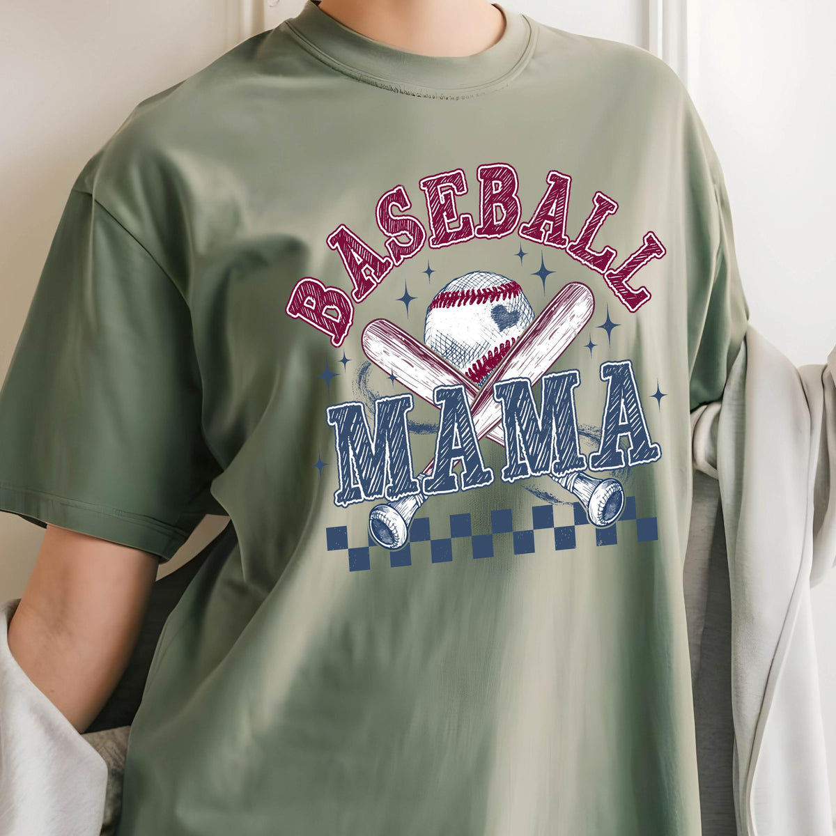 May include: A green t-shirt with a graphic design of two crossed baseball bats and a baseball with the text "Baseball Mama" in a red and blue font.