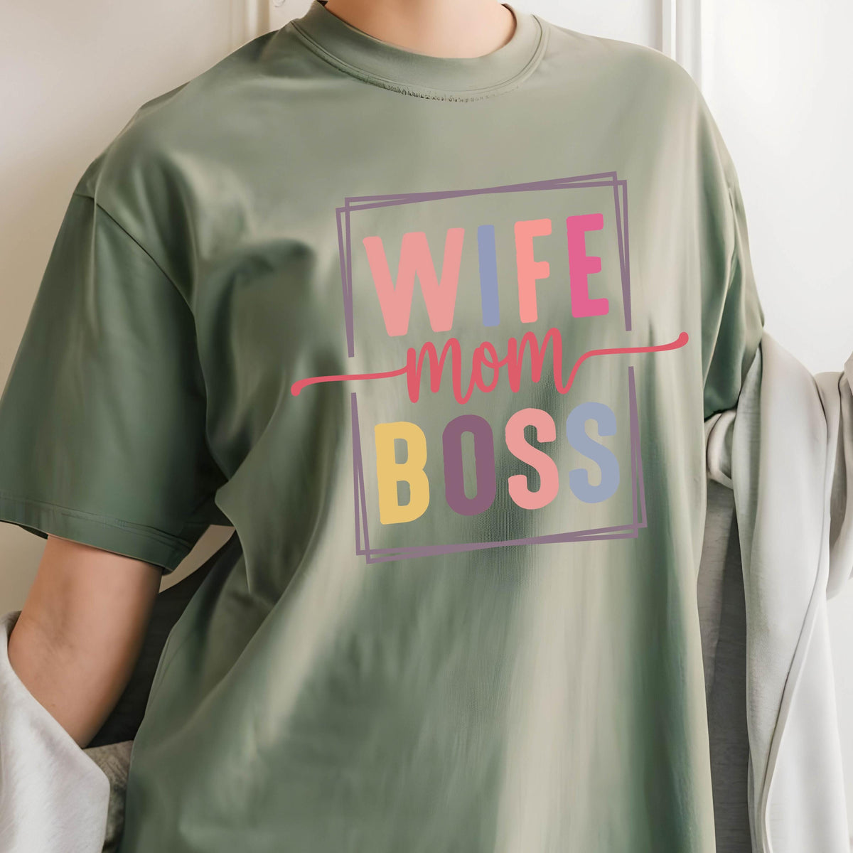 May include: Green t-shirt with a colorful graphic that says "Wife Mom Boss" in a box.