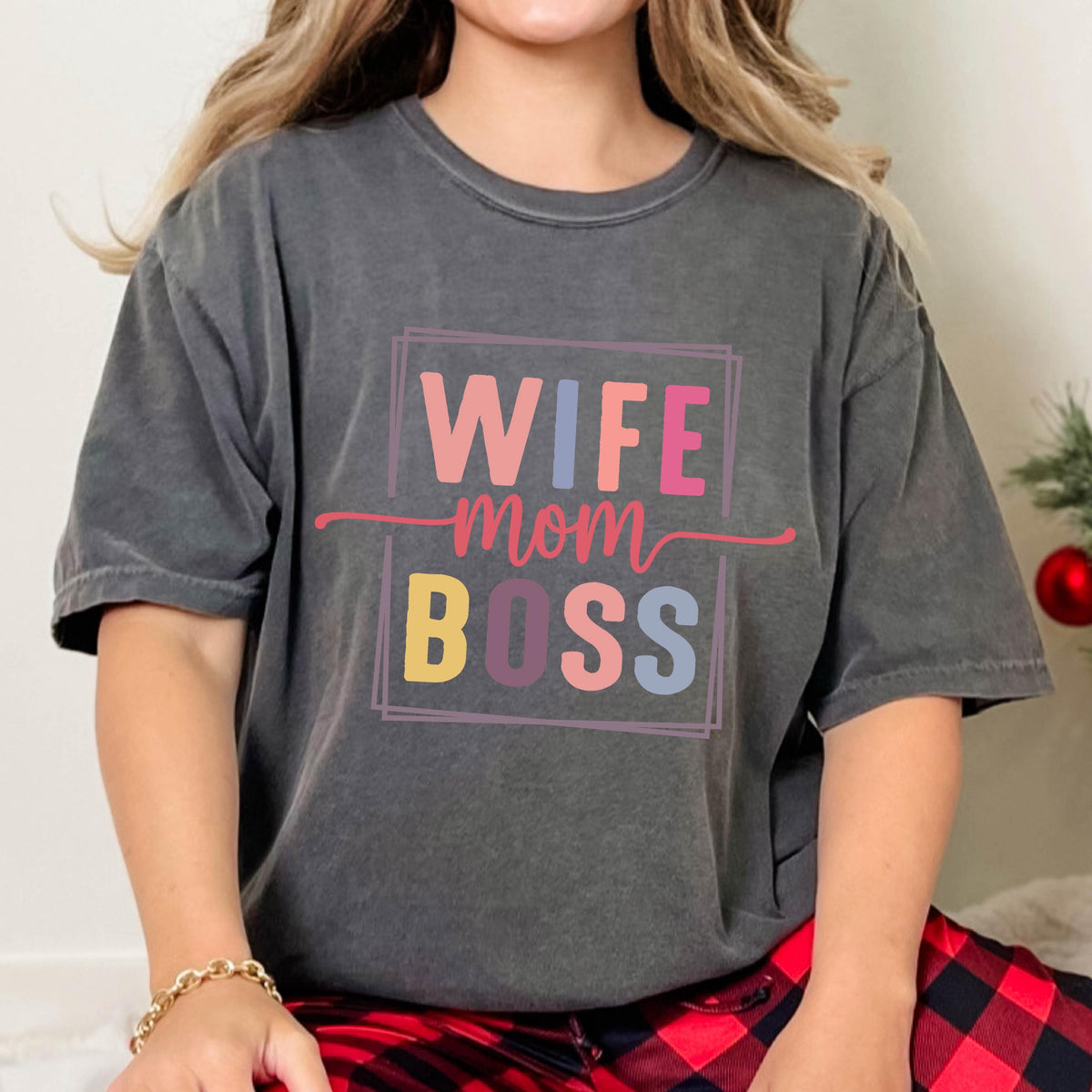 May include: A gray t-shirt with the text "WIFE MOM BOSS" in a colorful box. The text is in a retro font style.