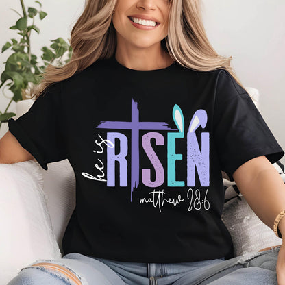 May include: Black t-shirt with a colorful graphic that says "He is Risen" with a cross and bunny ears. The text "Matthew 28:6" is below the graphic.