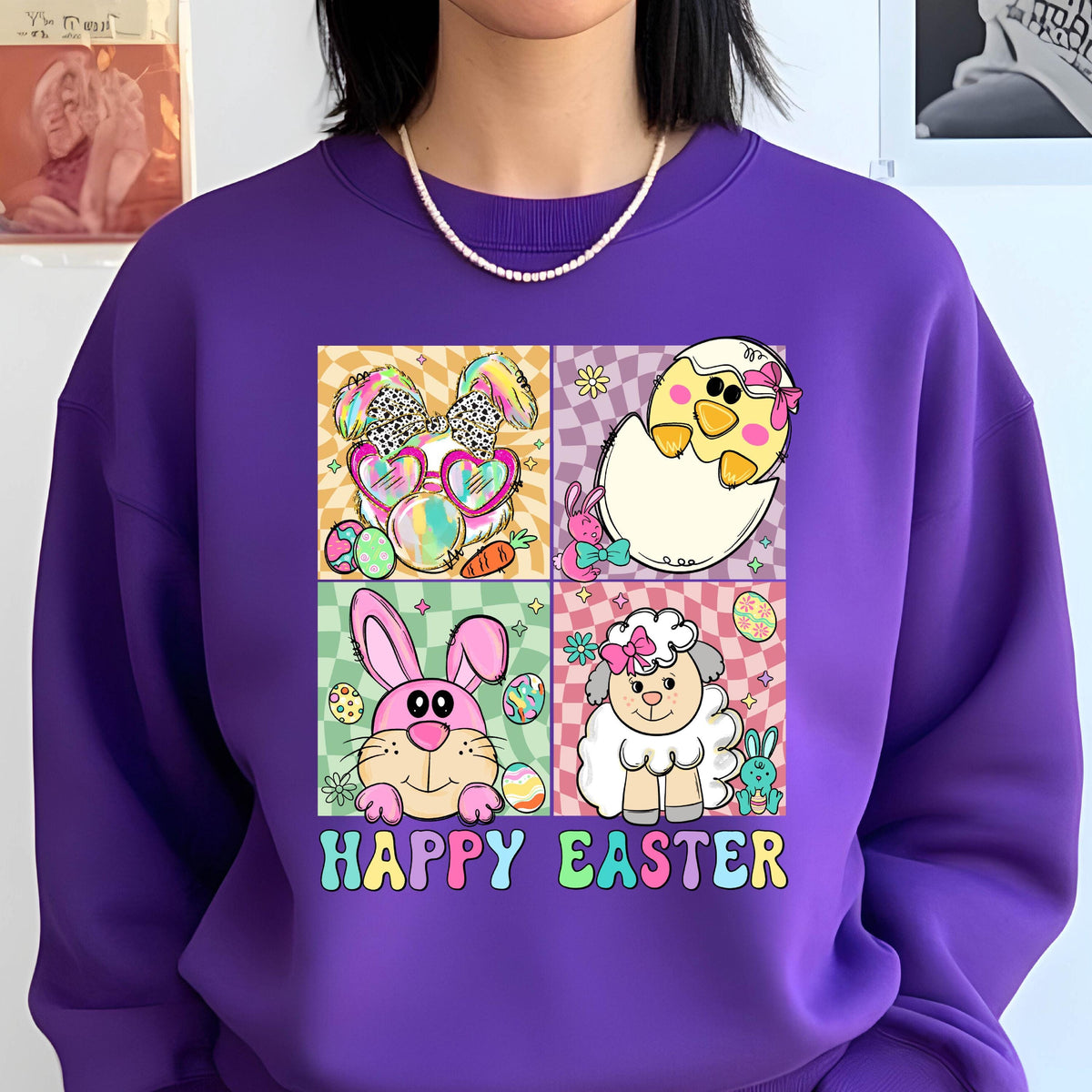 May include: Purple sweatshirt with a graphic of four cartoon animals, a bunny, a chick, a lamb, and a rabbit, with Easter eggs and the text "Happy Easter".