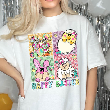 May include: White t-shirt with a colorful graphic design featuring a bunny, chick, lamb, and eggs. The text "Happy Easter" is printed below the graphic.