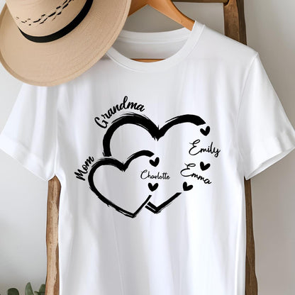 May include: White t-shirt with a black design of two interlocking hearts. The text "Grandma" is above the hearts, and the names "Mom", "Charlotte", "Emily", and "Emma" are inside the hearts.