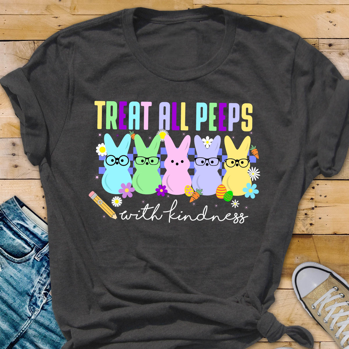 May include: A dark grey t-shirt with a graphic of five colorful peeps wearing glasses and the text "Treat all peeps with kindness".