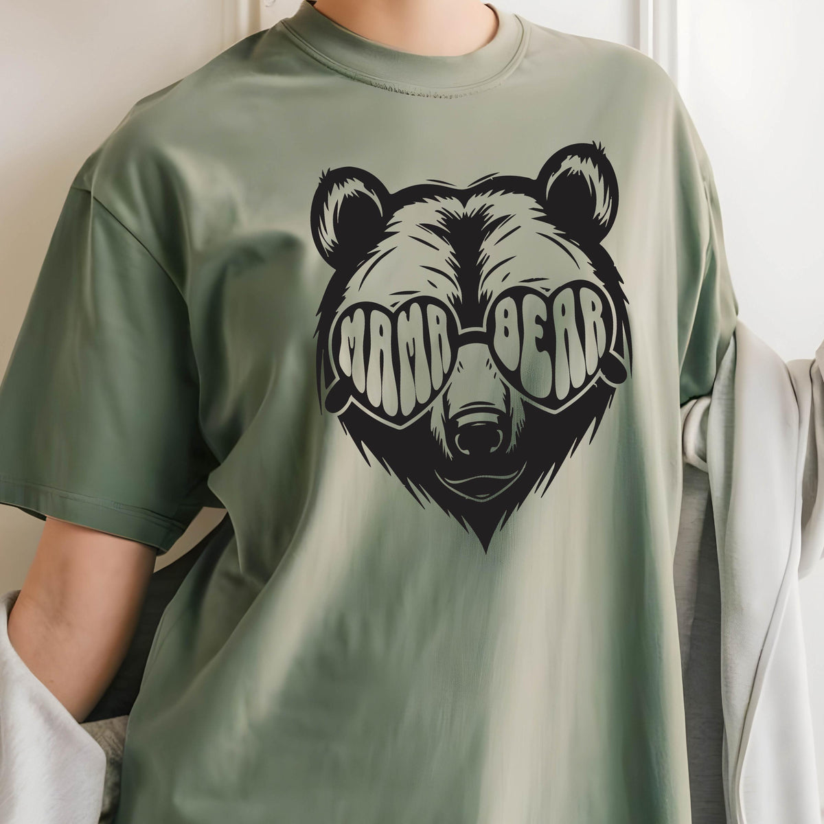 May include: Green t-shirt with a black bear wearing heart-shaped sunglasses that say "Mama Bear".