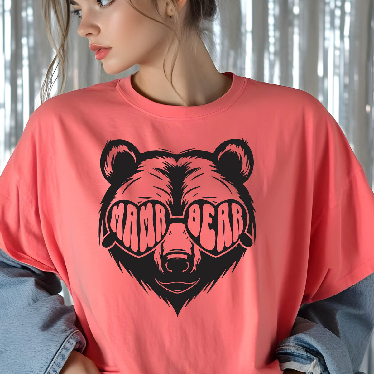 May include: A coral pink t-shirt with a black graphic of a bear wearing heart-shaped sunglasses that say "Mama Bear".