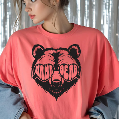 May include: A coral pink t-shirt with a black graphic of a bear wearing heart-shaped sunglasses that say "Mama Bear".