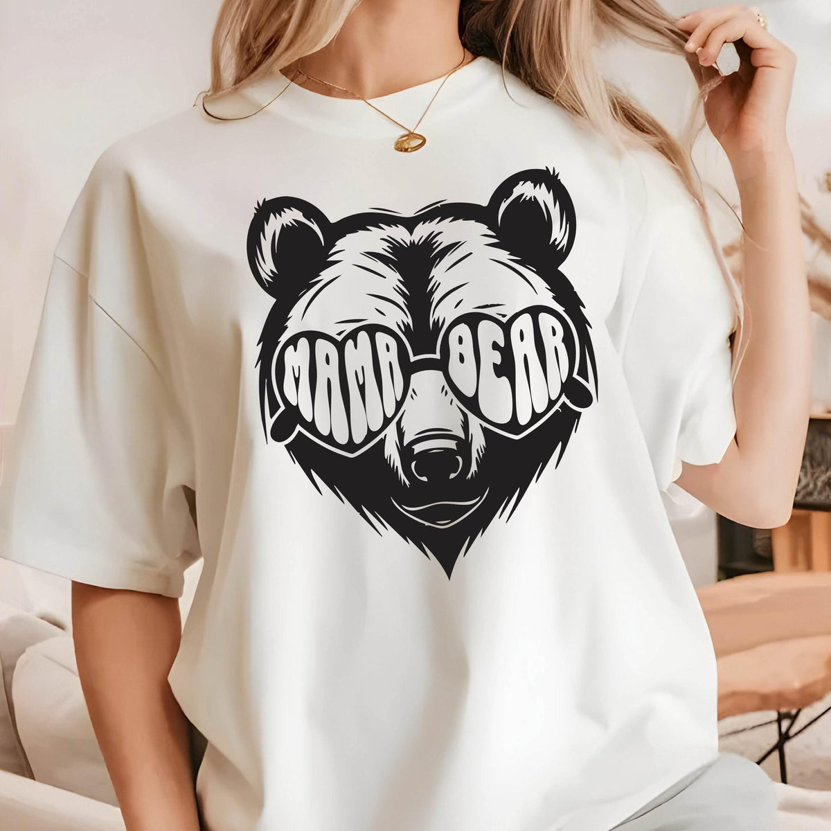 May include: White t-shirt with a black and white illustration of a bear wearing heart-shaped sunglasses that say "Mama Bear".
