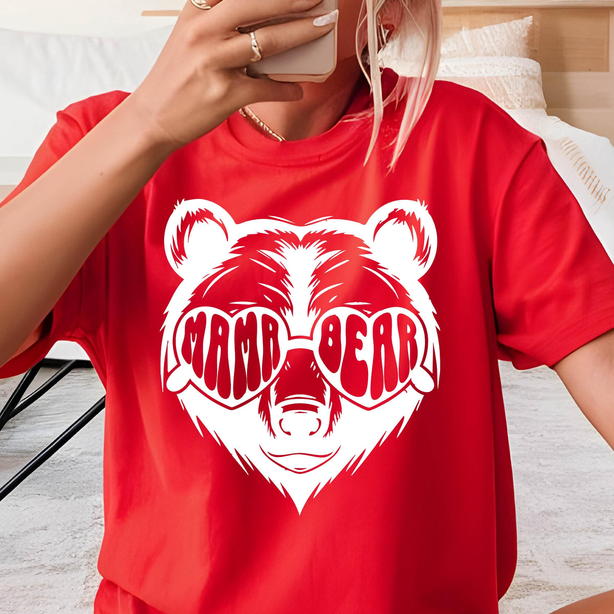 May include: Red t-shirt with a white graphic of a bear wearing heart-shaped sunglasses that say "mama bear".