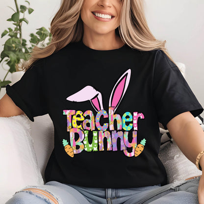 May include: Black t-shirt with the text "Teacher Bunny" in colorful letters, featuring bunny ears and carrots. The design is likely for Easter or a teacher-related event.