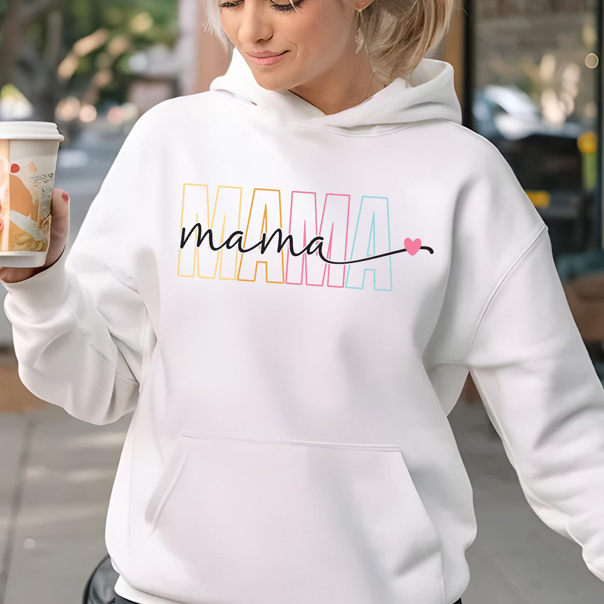 May include: White hoodie with a rainbow colored "MAMA" graphic and the word "mama" written in black script with a small pink heart.