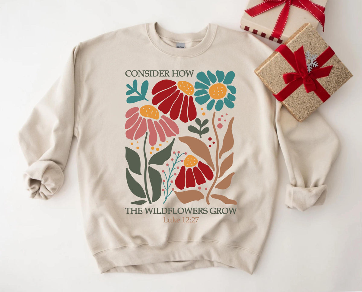 May include: Beige sweatshirt with a floral design and the text "Consider how the wildflowers grow Luke 12:27".
