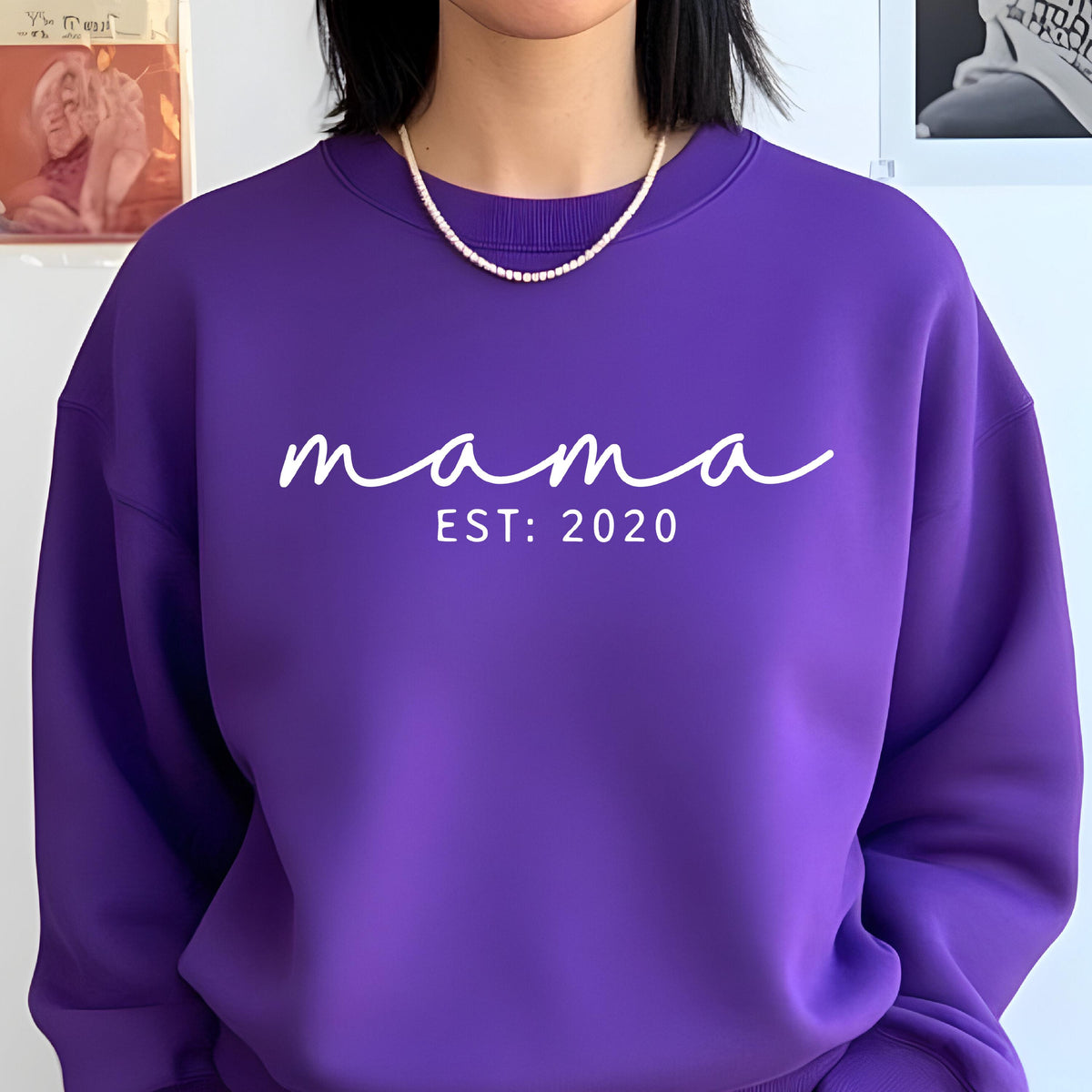 May include: Purple sweatshirt with the text "mama est: 2020" in white.