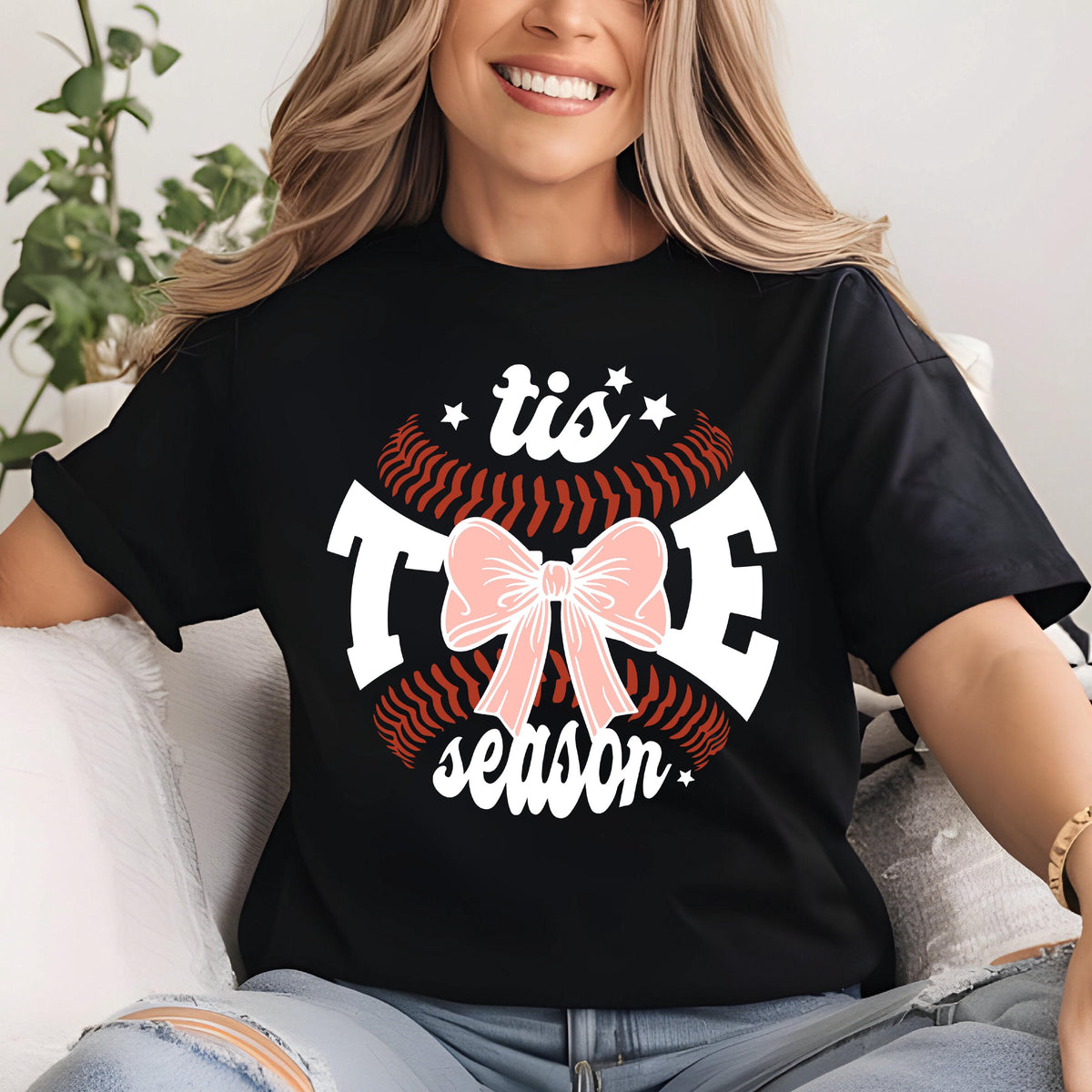 May include: Black t-shirt with a white baseball graphic and the text "tis the season" with a pink bow in the center.