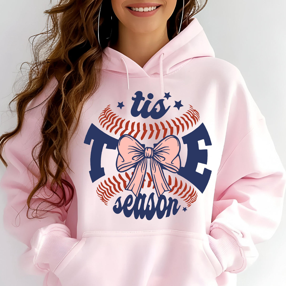 May include: Pink hoodie with a baseball graphic and the text "tis the season" in blue and red.