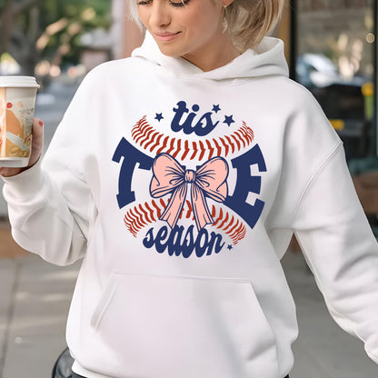 May include: White hoodie with a blue and red baseball graphic with a pink bow and the text "tis the season".