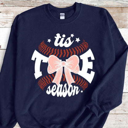 May include: Navy blue sweatshirt with a white baseball graphic and the text "tis the season" with a pink bow in the center.
