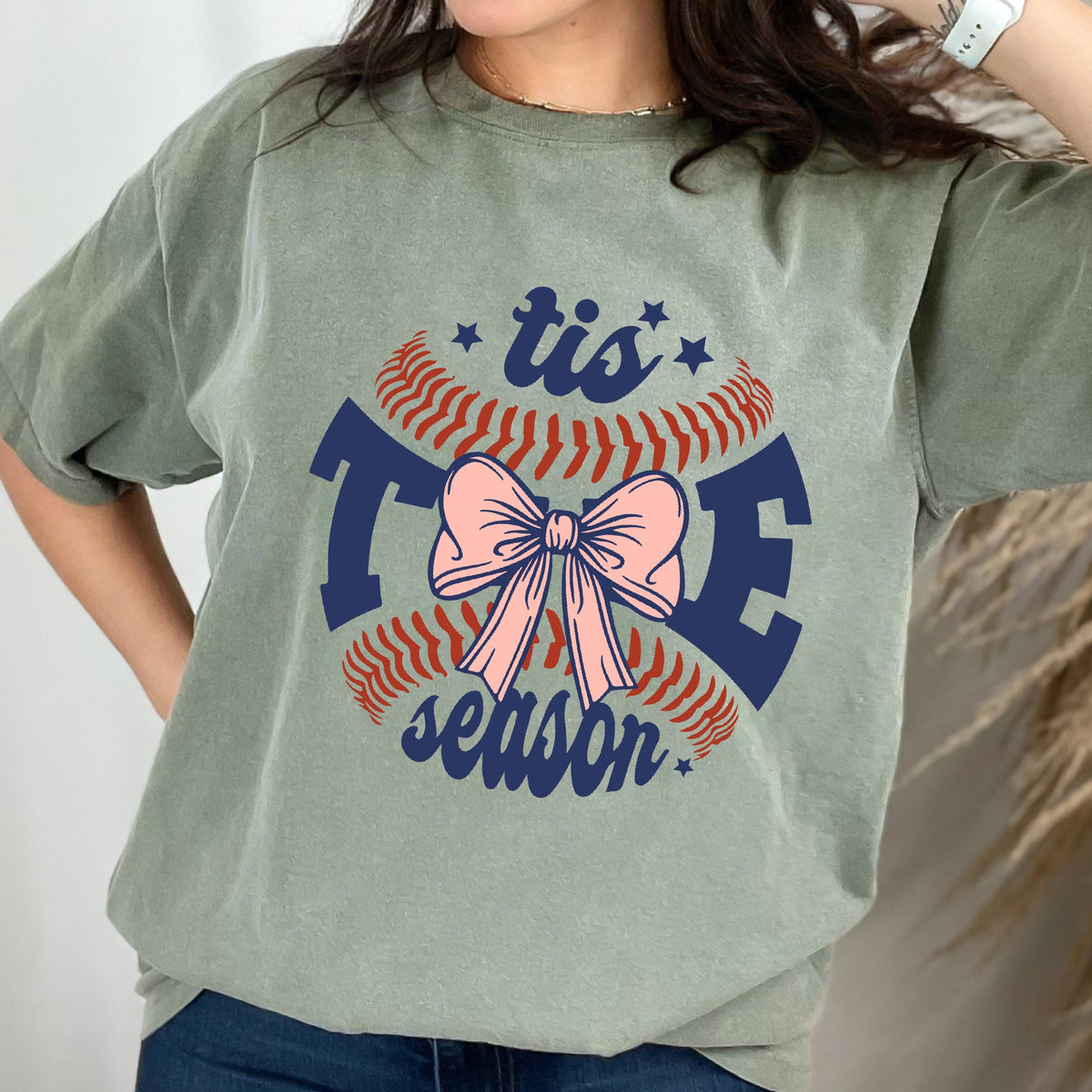 May include: Green t-shirt with a baseball graphic and the text "tis the season" with a pink bow in the center.