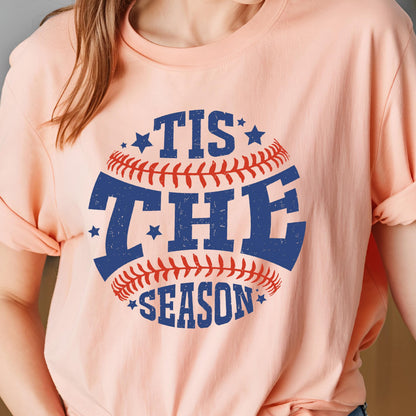 May include: A pink t-shirt with a baseball graphic and the text "Tis the Season" in blue and red.
