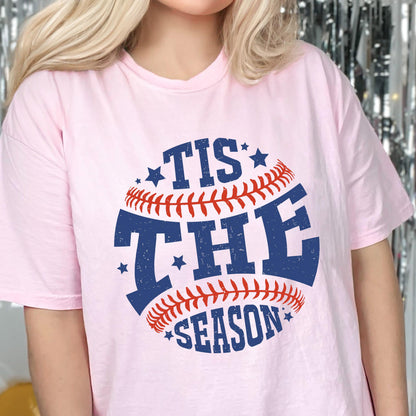 May include: Pink t-shirt with a blue and red baseball graphic that says "Tis the Season".