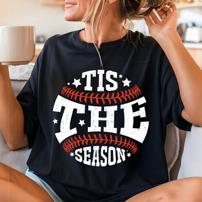 May include: Black t-shirt with a white baseball graphic and the text "Tis the Season" in a distressed font.