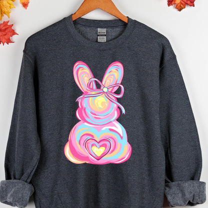 May include: A dark gray sweatshirt with a colorful Easter bunny design. The bunny is pink, blue, yellow, and orange with a pink bow. The bunny has a heart in the center of its body.