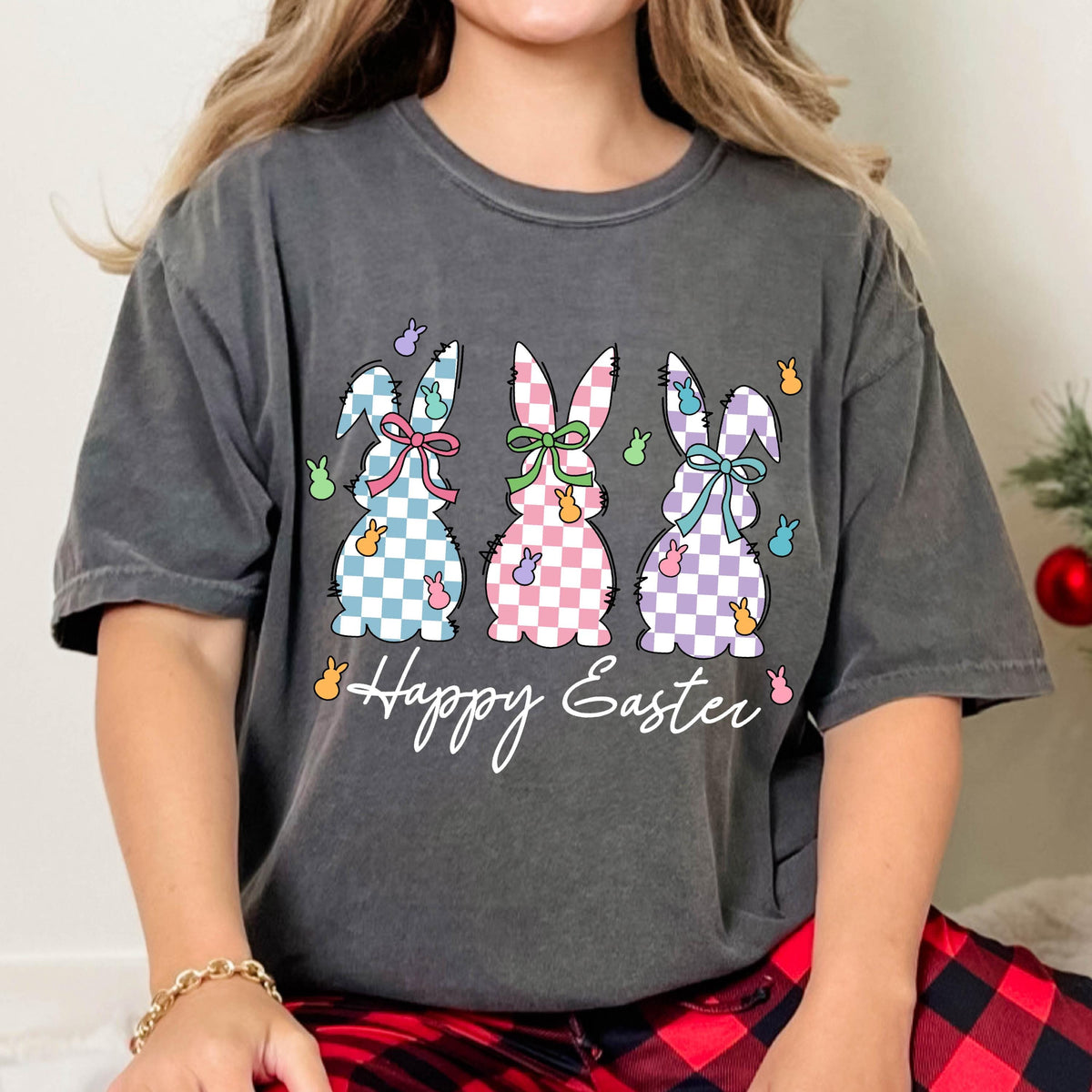 May include: A gray t-shirt with a graphic of three checkered Easter bunnies and the text "Happy Easter".